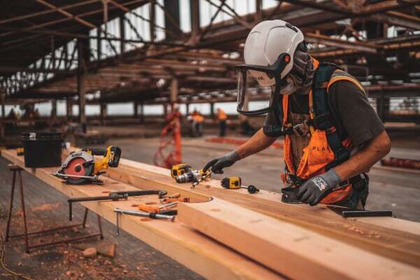 consturction worker at jobsite using tools