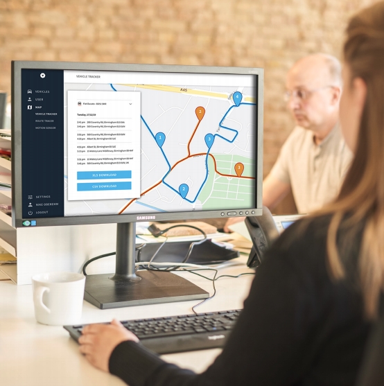 An employee using a business vehicle tracking on a desktop computer