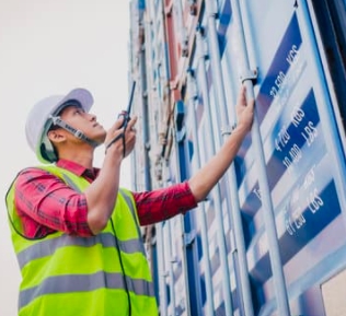 A lorry driver checking his lorry with a van check sheet